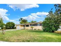Charming single-story home featuring a well-maintained lawn and attached garage at 4015 Ibis Dr, Orlando, FL 32803
