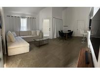 Bright living room featuring neutral decor, a modern sofa, and a glass coffee table at 970 N Spring Garden Ave # 621, Deland, FL 32720