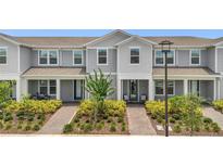 Charming townhome featuring a meticulously landscaped front yard and inviting entrance at 14335 Sapelo Beach Dr, Orlando, FL 32827