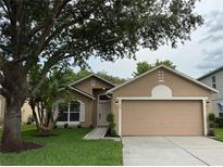 Charming single-story home with a well-maintained lawn, mature trees, and neutral color palette at 1639 Corner Meadow Cir, Orlando, FL 32820