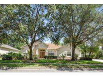 Charming single-story home featuring mature trees and a well-manicured lawn at 2674 Spicebush Loop, Apopka, FL 32712