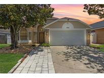Charming one story home with a two car garage and beautiful mature trees at 2933 Birmingham Blvd, Orlando, FL 32829