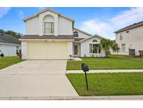 Charming two-story home with a well-maintained lawn and a two-car garage at 3018 Bransbury Ct, Kissimmee, FL 34747