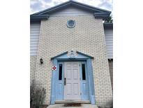 Charming brick home with a blue trimmed entrance and a centered, round window above the door at 3057 Aaron Burr Ave # 2, Winter Park, FL 32792
