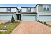 Charming townhome featuring a two-car garage and a well-manicured front yard at 4325 Switchgrass Ln, St Cloud, FL 34772