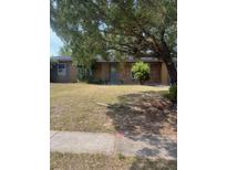 Charming single-story home with mature trees and a well-maintained front yard at 4820 Kathy Jo Ter, Orlando, FL 32808
