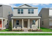 Charming two-story home featuring a stone-accented facade, covered porch, and beautifully landscaped front yard at 490 Belmond Dr, Debary, FL 32713