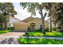 Charming one-story home with a well-manicured lawn, paver driveway, and beautiful landscaping at 6160 Froggatt St, Orlando, FL 32835