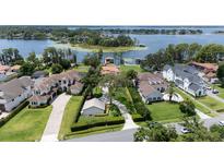 Luxury lakeside homes boasting manicured lawns and mature trees with private boat docks at 11018 Lake Butler Blvd, Windermere, FL 34786