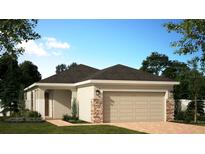 Charming single-story home with a two-car garage, stone accents, and well-manicured landscaping at 1369 Sawgrass Hammock Ln, Davenport, FL 33837