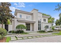 Striking two-story modern home featuring a stone accent wall and professionally landscaped front yard at 1820 Englewood Rd, Winter Park, FL 32789