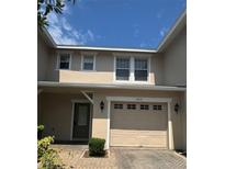 Charming townhome with a one-car garage and neutral exterior paint at 2018 Cypress Bay Blvd, Kissimmee, FL 34743