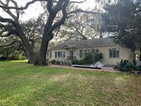 Charming single-story home with a spacious yard and mature trees providing ample shade at 2223 Kilmer Ln, Apopka, FL 32703