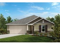 Charming one-story home with a two-car garage, lush lawn, and beautiful landscaping at 2644 Hancock Crossing Dr, Bartow, FL 33830