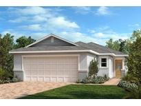 Charming one-story home with a two-car garage, lush landscaping, and a brick driveway at 3281 Rolling Plains Cir, Clermont, FL 34714