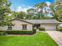 Charming single-story home with manicured lawn, trimmed hedges, and attached two-car garage at 404 Broadview Ave, Altamonte Springs, FL 32701