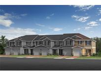 Charming townhomes featuring attached garages and manicured front lawns under a bright blue sky at 504 Pine Ridge Ct, Lake Wales, FL 33859