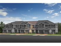 Modern townhome exterior with individual garages, craftsman details, and welcoming curb appeal at 512 Pine Ridge Ct, Lake Wales, FL 33859