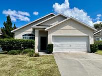 Charming single-story home with a well-manicured lawn and an attached two-car garage at 5559 Pats Pt, Winter Park, FL 32792