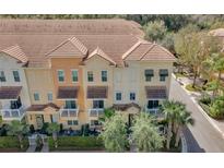 Charming townhomes with manicured lawns, private balconies, and tile roofs in a sunny neighborhood at 813 Greybull Run, Lake Mary, FL 32746