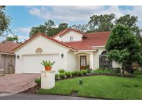 Charming single-Gathering home showcasing a well-manicured lawn, tile roof, and two-car garage at 1364 Augusta National Blvd, Winter Springs, FL 32708