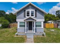 Charming two-story home featuring a symmetrical facade, gray siding, and a well-manicured lawn at 1504 Indiana Ave, St Cloud, FL 34769