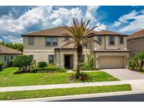 Charming home featuring lush landscaping, well manicured lawn and a two-car garage at 1597 Katie Cv, Sanford, FL 32771