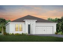 Beautiful single-story home with a two-car garage, manicured lawn, and tropical trees in the background at 2610 Serenity Garden Dr, Kissimmee, FL 34744