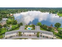 Stunning aerial view showcasing a lakefront building with a pool and serene surroundings at 2893 S Osceola Ave # E6, Orlando, FL 32806