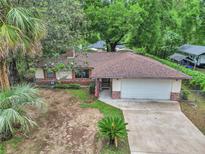 Charming single-story home featuring a brick and siding exterior, well-maintained lawn and a two-car garage at 6421 Nw 61St St, Ocala, FL 34482
