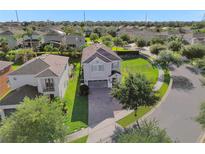 Beautiful two-story home featuring a well-manicured lawn, brick driveway and mature trees in a lovely neighborhood at 7524 Marker Ave, Kissimmee, FL 34747