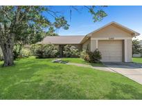 Charming one-story home featuring a lush green lawn and mature trees, offering great curb appeal at 100 Madden Ave, Sanford, FL 32773