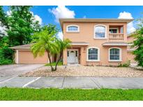Charming two-story home featuring stucco siding, arched windows, and a well-manicured front yard at 1046 Morris Ave # 1046, Orlando, FL 32803
