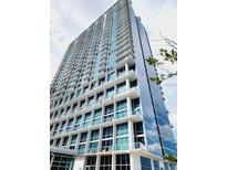 A sleek modern building with floor-to-ceiling glass and private balconies provides stunning views at 150 E Robinson St # 419, Orlando, FL 32801