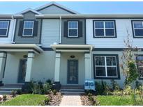 Charming townhome showcasing a welcoming facade, neat landscaping, and a well-maintained entryway at 15316 Burgtheater Dr, Winter Garden, FL 34787