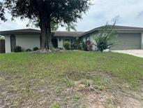 Charming single-story home with mature trees and well-maintained lawn at 1812 Firwood Ct, Orlando, FL 32818