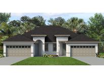 Charming single-story home with a manicured lawn, neutral color palette, and a two-car garage perfect for curb appeal at 2303 Leela Cir, Tavares, FL 32778