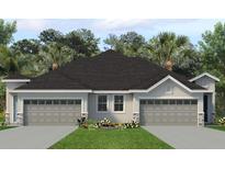 Charming single-story home with a two-car garage, manicured lawn, and tasteful landscaping at 2307 Leela Cir, Tavares, FL 32778