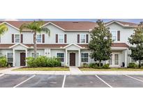 Charming townhouse with well-maintained landscaping and designated parking spaces at 3203 Oyster Ln, Kissimmee, FL 34747