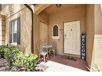 Charming front porch area with seating and a welcoming entrance at 3214 Calabria Avenue, Davenport, FL 33897