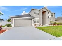 Charming home featuring a two-car garage and well-maintained landscaping at 3824 Blue Dasher Dr, Kissimmee, FL 34744