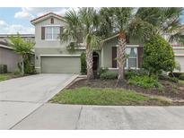 Charming two-story home with well-manicured lawn and two car garage at 7033 Oakwood St, Davenport, FL 33837
