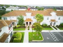 Beautiful condo showcasing a well-manicured lawn and a charming covered entryway for a welcoming curb appeal at 9061 Dogleg Dr, Davenport, FL 33896