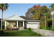 Charming single-story home with a manicured lawn, a two car garage and a welcoming front porch at 13518 Maria Lavin Circle Rd, Orlando, FL 32828