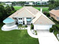 Stunning exterior of a well-maintained home with manicured lawn and an amazing tile roof at 235 Promenade Cir, Lake Mary, FL 32746