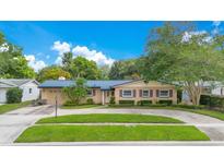 Beautiful home with a well-kept lawn, manicured shrubs, and contrasting shutters that add character to the facade at 3405 Werber St, Orlando, FL 32806