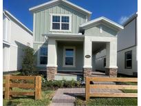 Charming two-story home with a quaint front porch and well-maintained landscaping at 5324 Center Lake Ranch Blvd, St Cloud, FL 34771