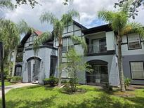Charming two-story condo with balconies, surrounded by lush palm trees and well-maintained landscaping at 5501 Pga Blvd # 4723, Orlando, FL 32839