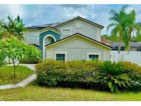 Charming two-story home featuring a landscaped front yard, inviting facade, and well-maintained exterior at 7727 Glynde Hill Dr, Orlando, FL 32835