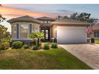 Charming single-story home with manicured landscaping, neutral paint, and an inviting double-door entrance at 9426 Burnam Dr, Weeki Wachee, FL 34613